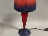 a red and blue lamp that is on a table
