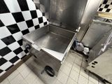 an image of a commercial kitchen with a checkered wall