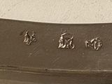 a close up of a silver spoon with writing on it