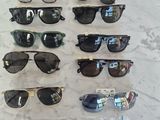 many pairs of sunglasses on display on the table