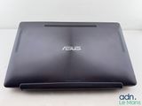 the back of a black laptop computer sitting on top of a white table