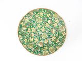 an image of a green and yellow plate with flowers on it