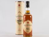 a bottle of glendevery whisky next to a cardboard box