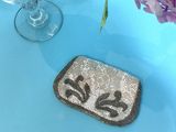 a small purse sitting on a table next to a vase of flowers