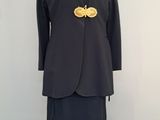 an image of a woman ' s dress and jacket on a mannequin stand