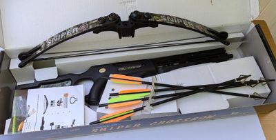 bow and arrows in a box with other items in it