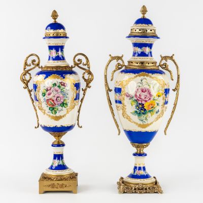 pair of blue and white vases with floral designs on them