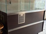a large glass display case in the middle of a room