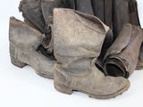 a pile of old boots that are sitting on the ground