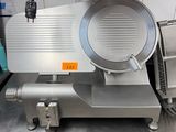 an image of a commercial meat slicer in a kitchen
