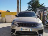 a silver car parked in front of a building