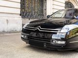 a black car that is parked in front of a building