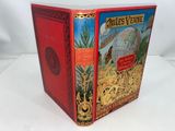 an old red book with a picture of a globe on the cover
