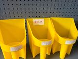 three yellow plastic bins are on a shelf in a store