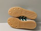 pair of white and green tennis shoes sitting on top of a white table