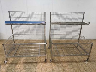 two metal shelvings that are sitting on the floor