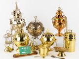 many different types of brass objects on a white surface