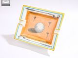 a small tray with a golf ball and tees on it