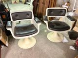 two chairs that are sitting in the middle of a room