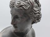 statue of a woman holding a bird in her hand