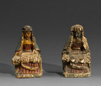 two figurines of a woman and a man sitting next to each other