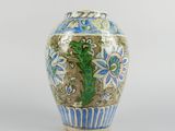 un vase bleu et blanc posé sur une surface blanche