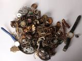 a pile of assorted jewelry on a white surface