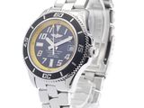 the watch is on a silver bracelet with a blue dial