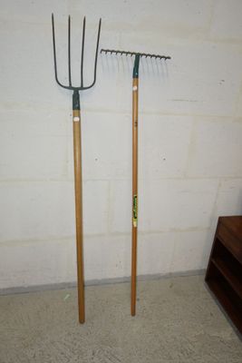 two pitchforkes that are standing next to each other