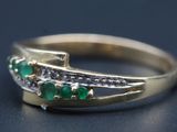 une image montrant un gros plan d'une bague en or sertie d'émeraudes