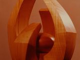 a wooden sculpture that is on a table