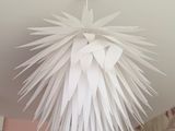 a white light hanging from the ceiling in a room