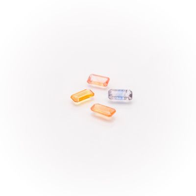 three different colored pills sitting on top of a white surface