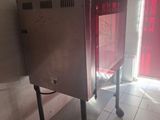 a metal cabinet in the middle of a tiled floor