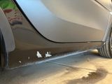 a close up of a car ' s side door with paint on it