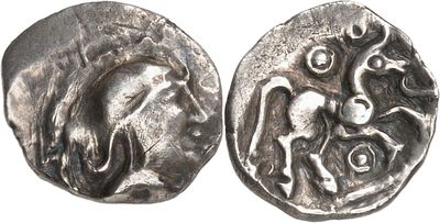 a close up of two silver coins on a white surface