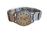 a watch that is sitting on a silver bracelet