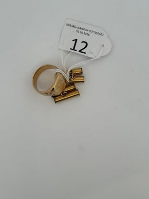 a gold ring with a number on it sitting on a table