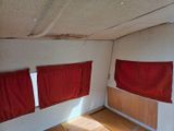two red curtains hanging from the ceiling in a room