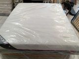 many mattresses stacked on top of each other in a room
