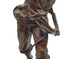 bronze statue of a man with a hat and a baseball bat