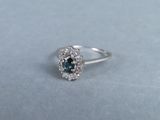 an image of a ring with a blue and white diamond center