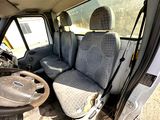 the interior of a van with two seats and a steering wheel