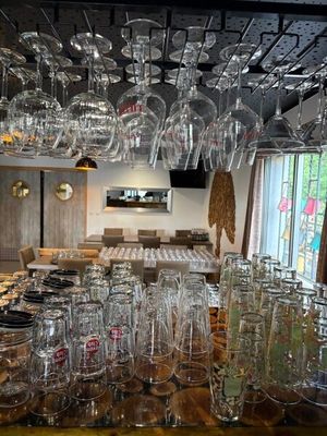 many glasses hanging from the ceiling in a restaurant