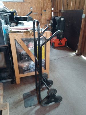 a dolly cart with wheels in a garage next to a stack of boxes