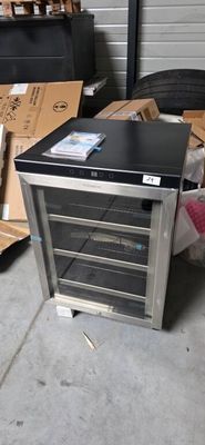 a small refrigerator that is sitting on the floor