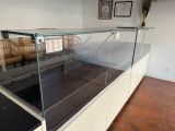 a glass display case in the middle of a room