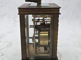 a clock that is sitting on a marble surface