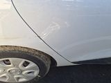 a close up of a white car with a flat tire