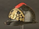 a black helmet with a gold and red emblem on it